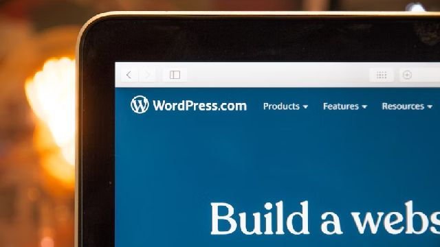 Image of a laptop showing the WordPress homepage.