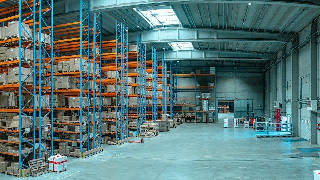 Photo of a warehouse with stocked pallet racks.