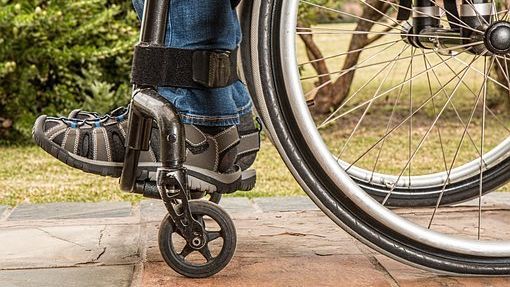 Photo of a person's legs sited on a wheelchair.