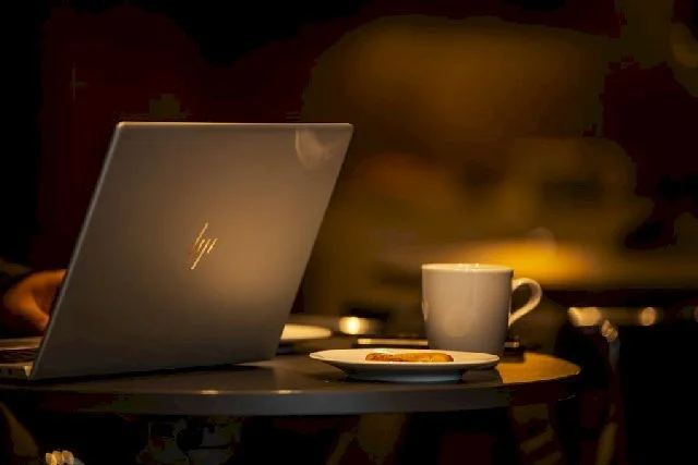 Photo of an HP laptop atop a coffee table.