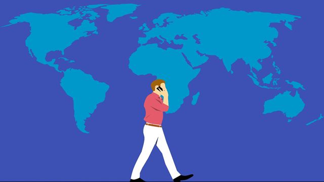 Illustration of a man talking on a phone in front of a backdrop of the world map.